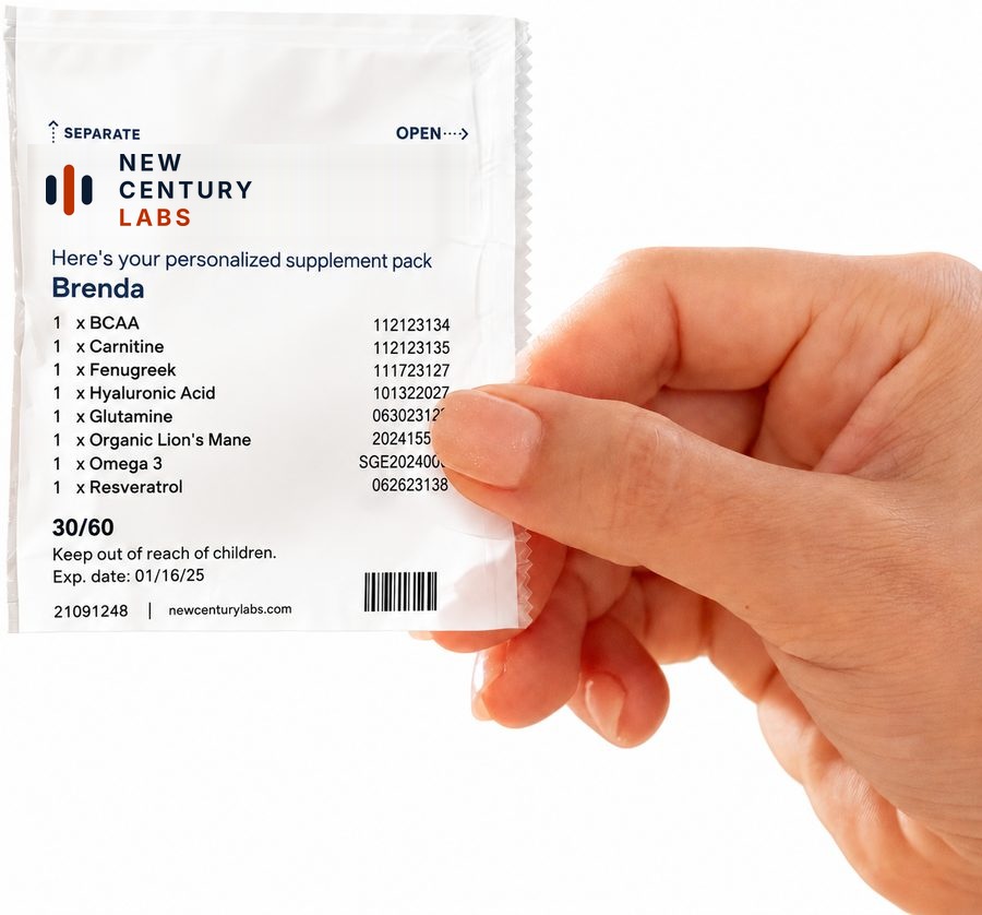 A hand holding a personalized daily supplement sachet printed with the patient's name and the ingredients in that day's pack.