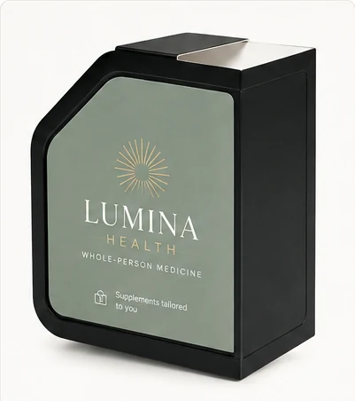 A dispenser carrying Lumina Health branding — sage panel with a gold sunburst mark.